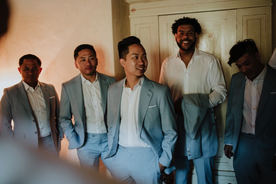 best men looking at the groom