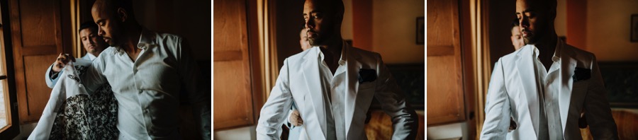 groom wears his white jacket before wedding