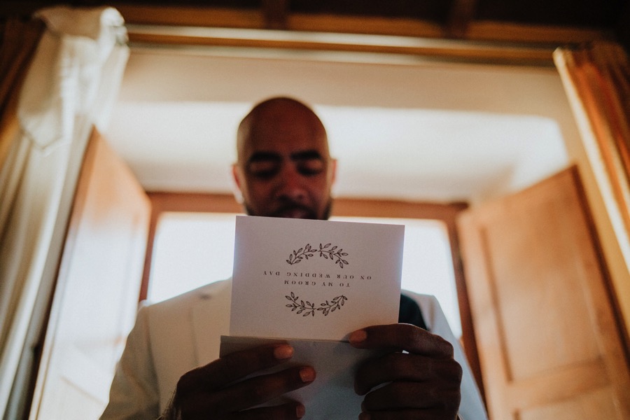 groom reading a message from the bride