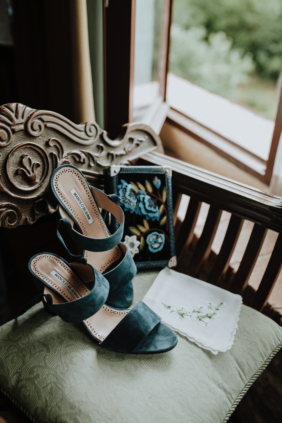 manolo blahnik wedding shoes in front of a window in pozze di lecchi