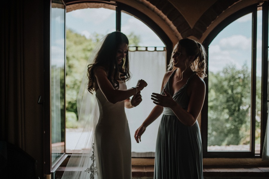 bride and bridesmaid getting ready