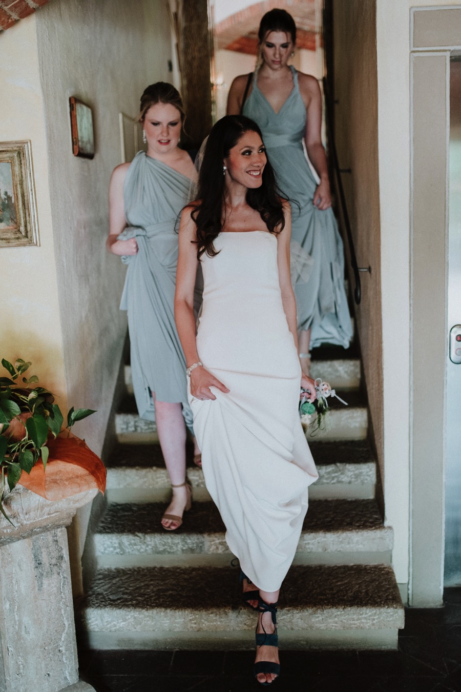 smiling bride with bridesmaids ready for her wedding