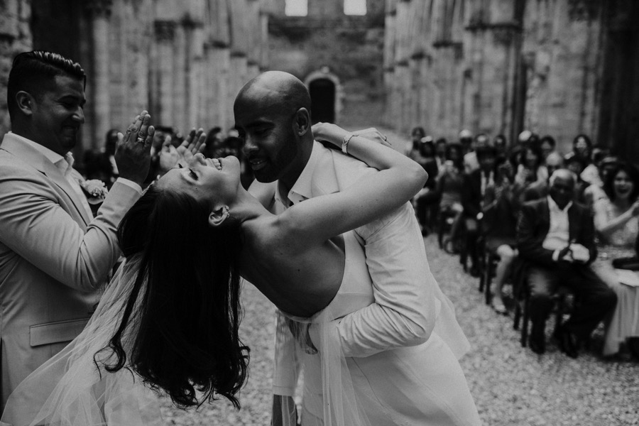 groom kissing bride in San Galgano