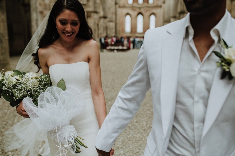bride and groom walking down the aisle San Galgano