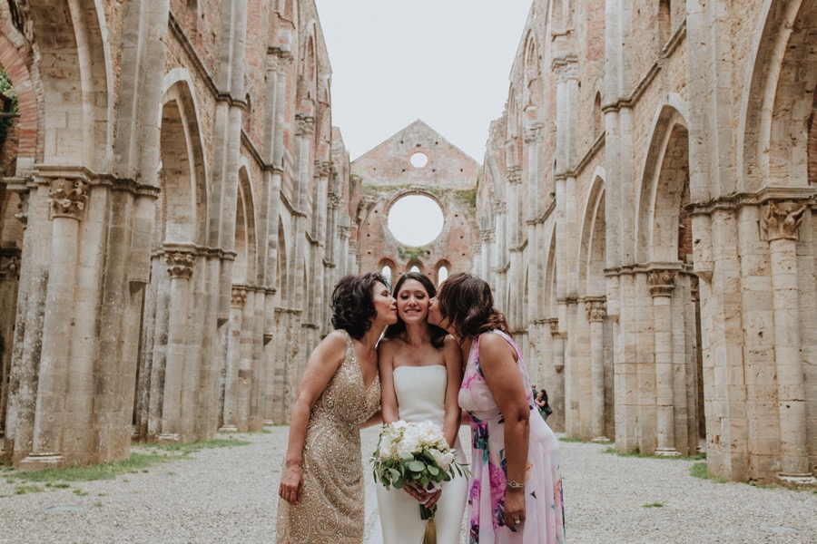 bride kissed by mother and mother in law San Galgano