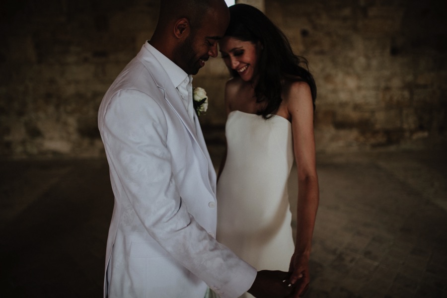 bride and groom wearing white dresses