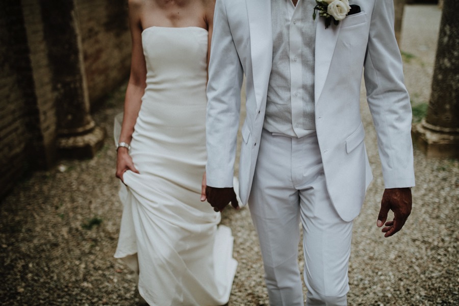 details of bride and groom dressed in white