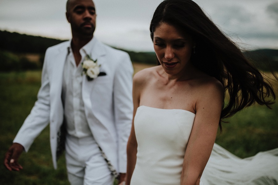 bride followed by groom dark moody style