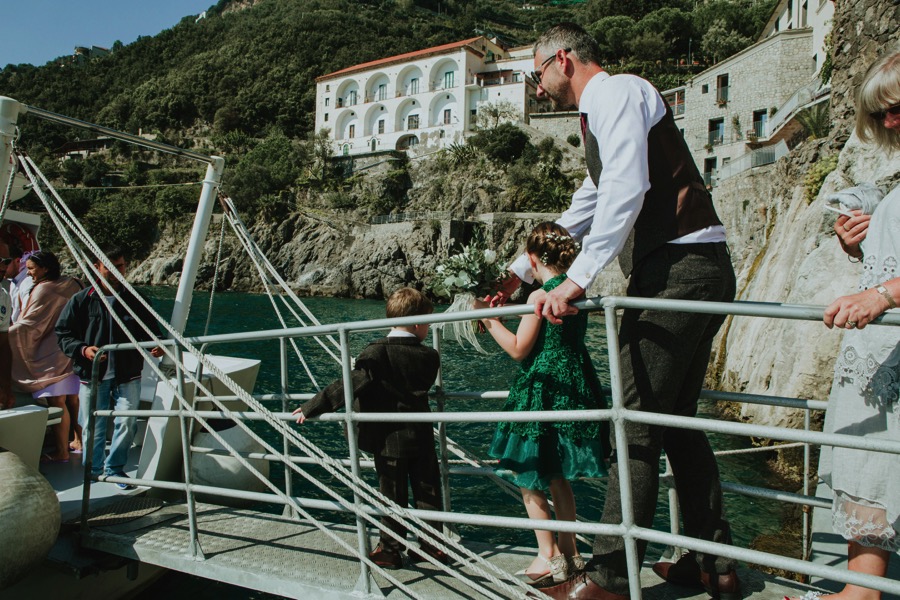 groom taking the ferry to santa Trofimena church in Amalfi