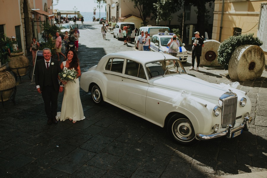 Bride arriving in Santa Trofimena Church with a classic car