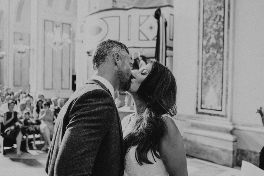 black and white portrait of bride and groom kissing in Santa Trofimena church