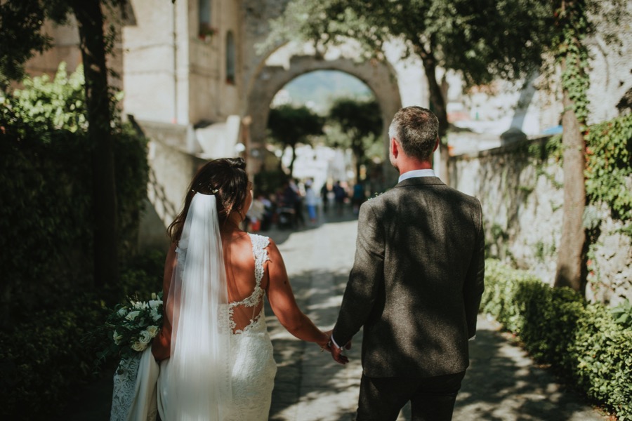 Bride and groom walking in the streets of Ravello during their destination wedding
