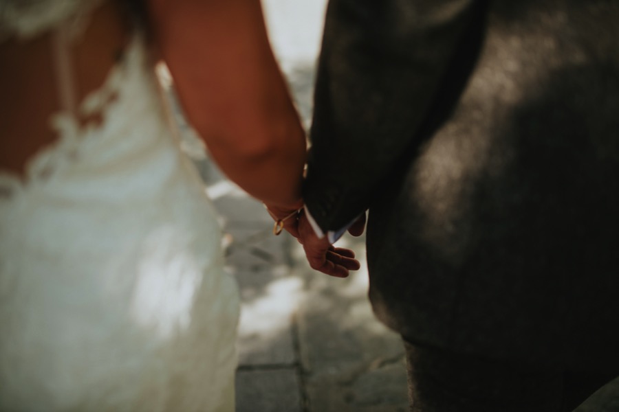 details of bride and groom hand while walking
