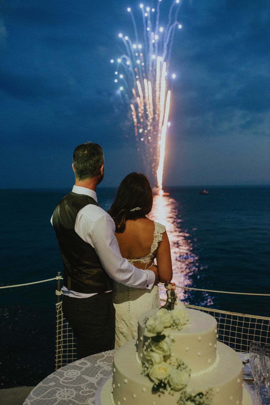 cutting of the cake with fireworks in the background in Hotel Marmorata