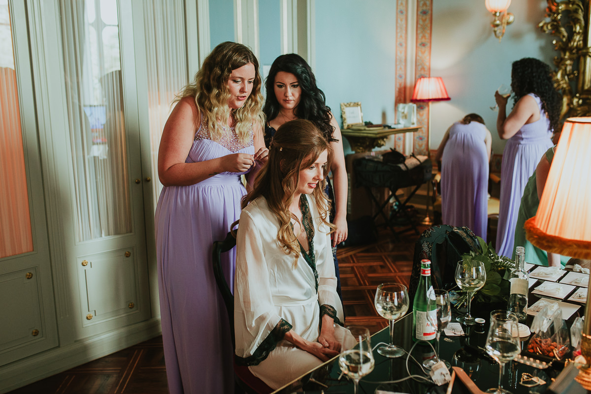 bridesmaids help the bride for getting ready