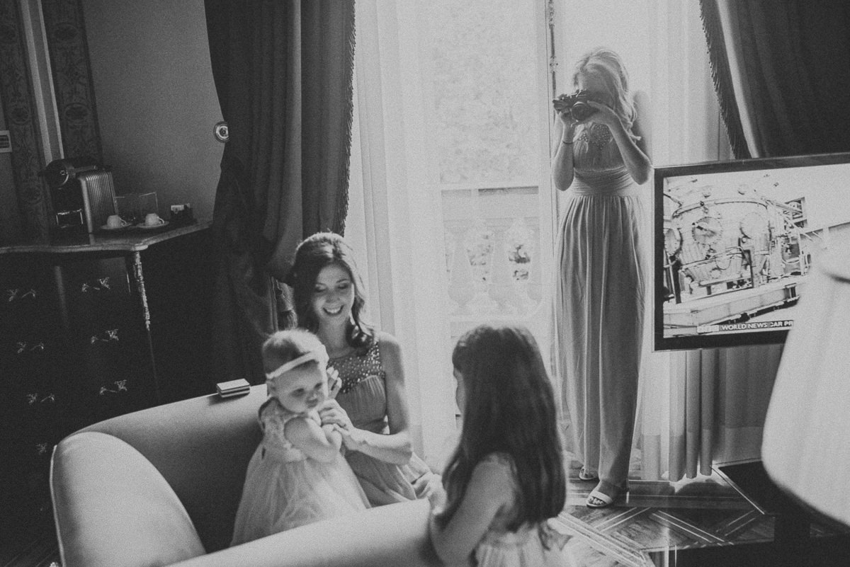 bride's sister taking pictures with her daughter