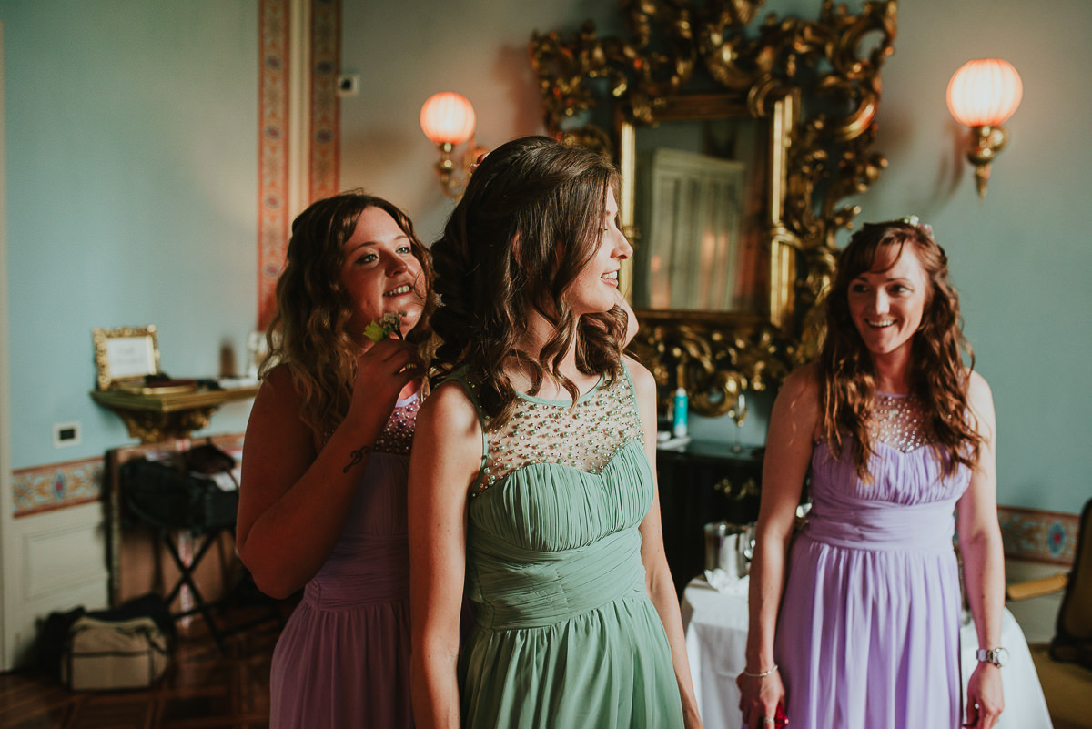 sister of the bride gets her hair done by the bridesmaids
