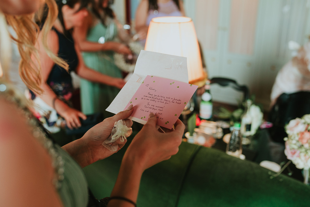 bridesmaids reading her thank you card 