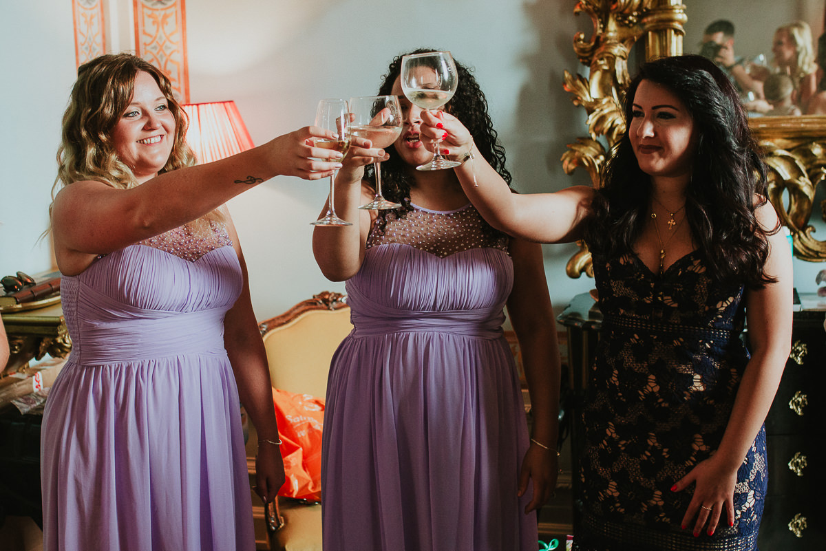 bridesmaids having toast before wedding