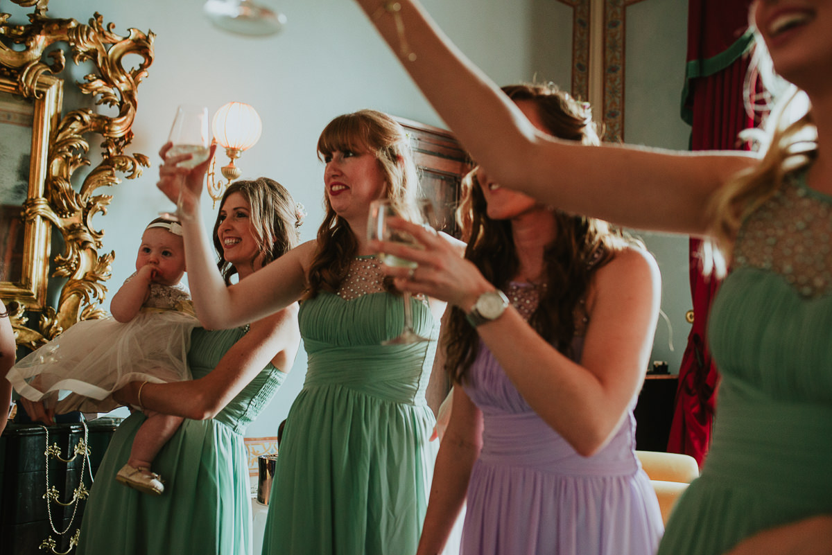 bridesmaids having toast before wedding