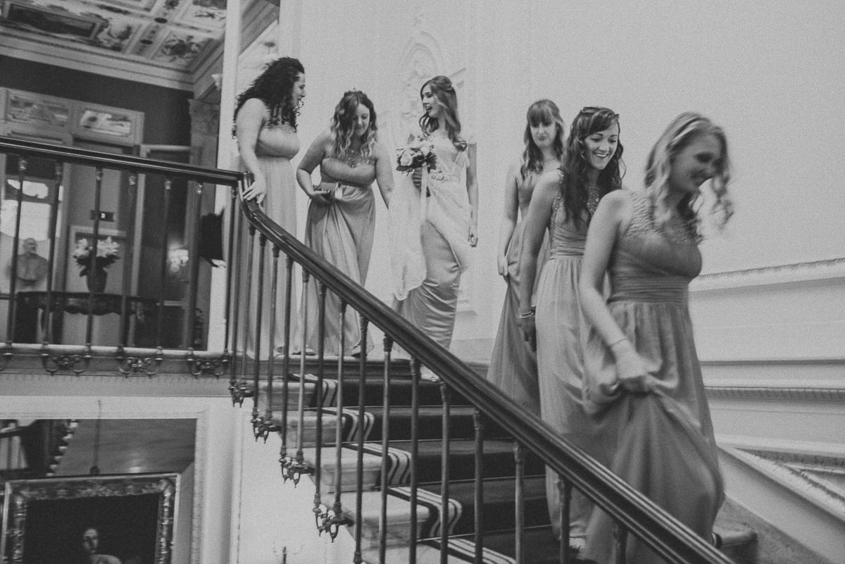 bride and bridesmaids walking down the stairs of Villa Cora Hotel