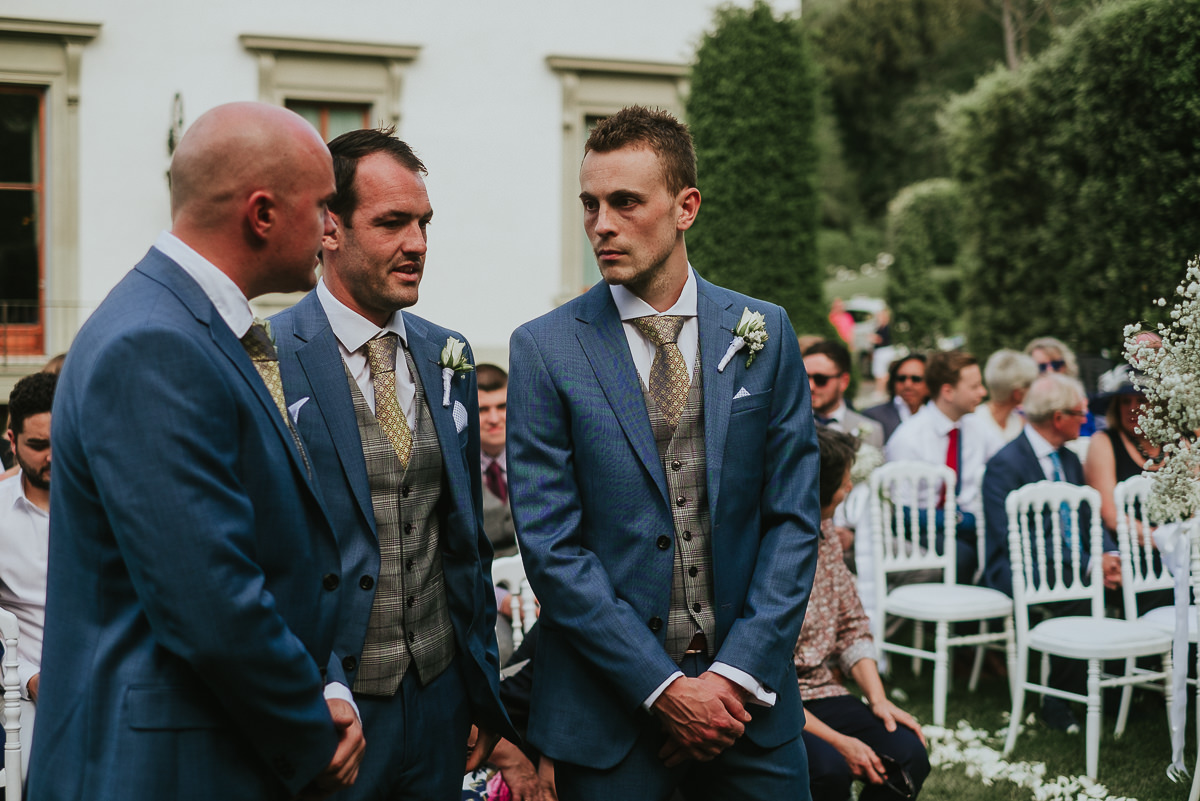 groom and best men on the garden of Villa Cora Hotel Florence waiting for the bride