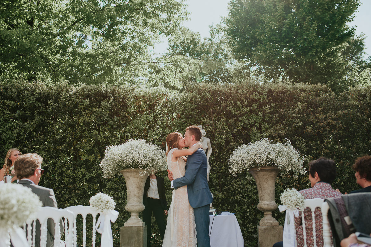 bride kissing groom in Villa Cora destination wedding florence