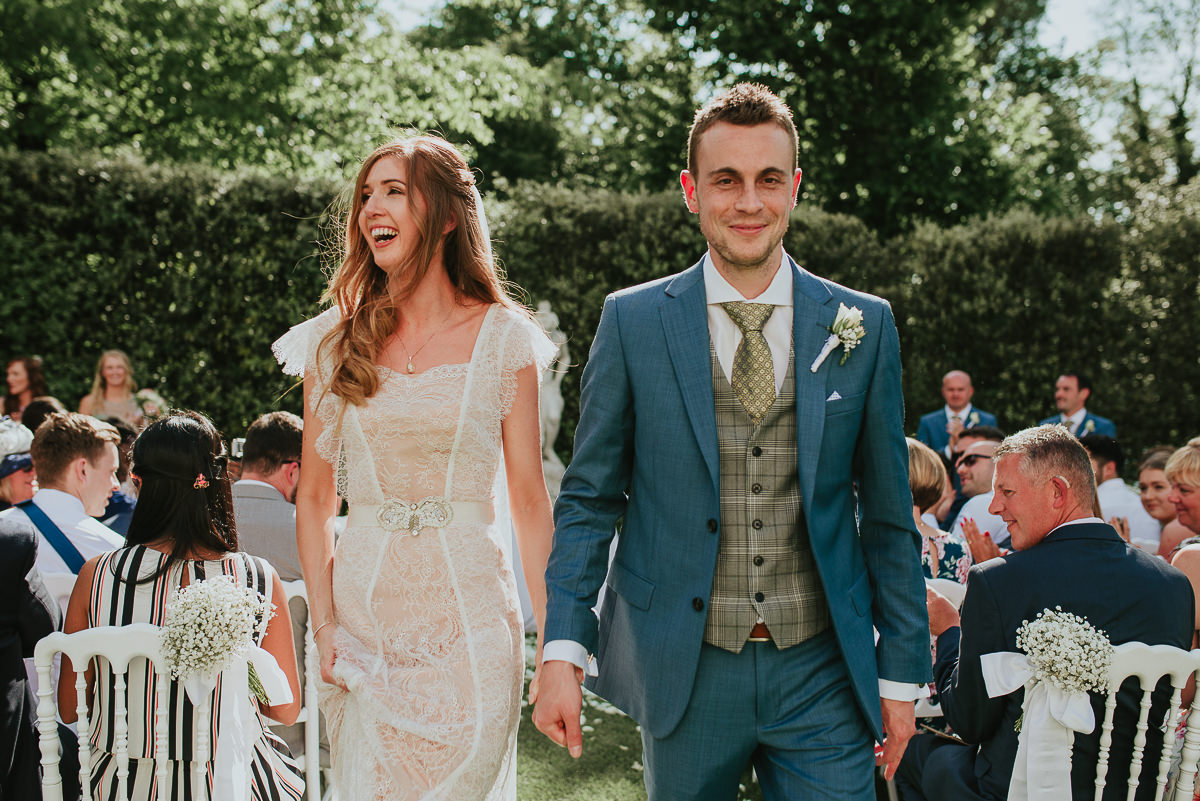 bride and groom walking down the aisle in Villa Cora Gardens