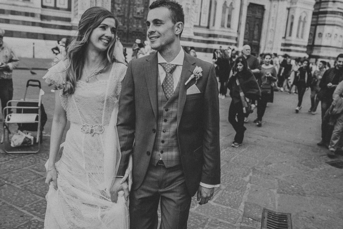 black and white bride and groom walking in Florence during a destination wedding in Italy