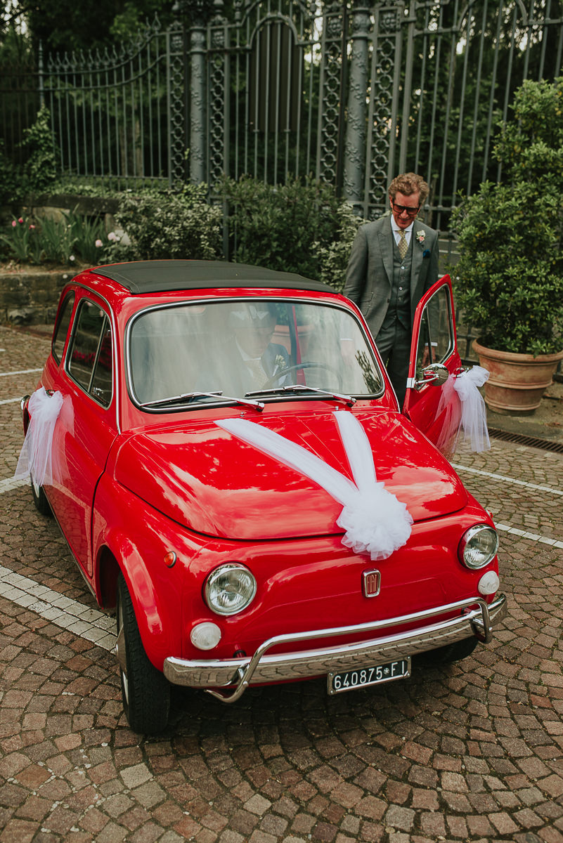 typical red italian 500 cinquecento dressed up for wedding