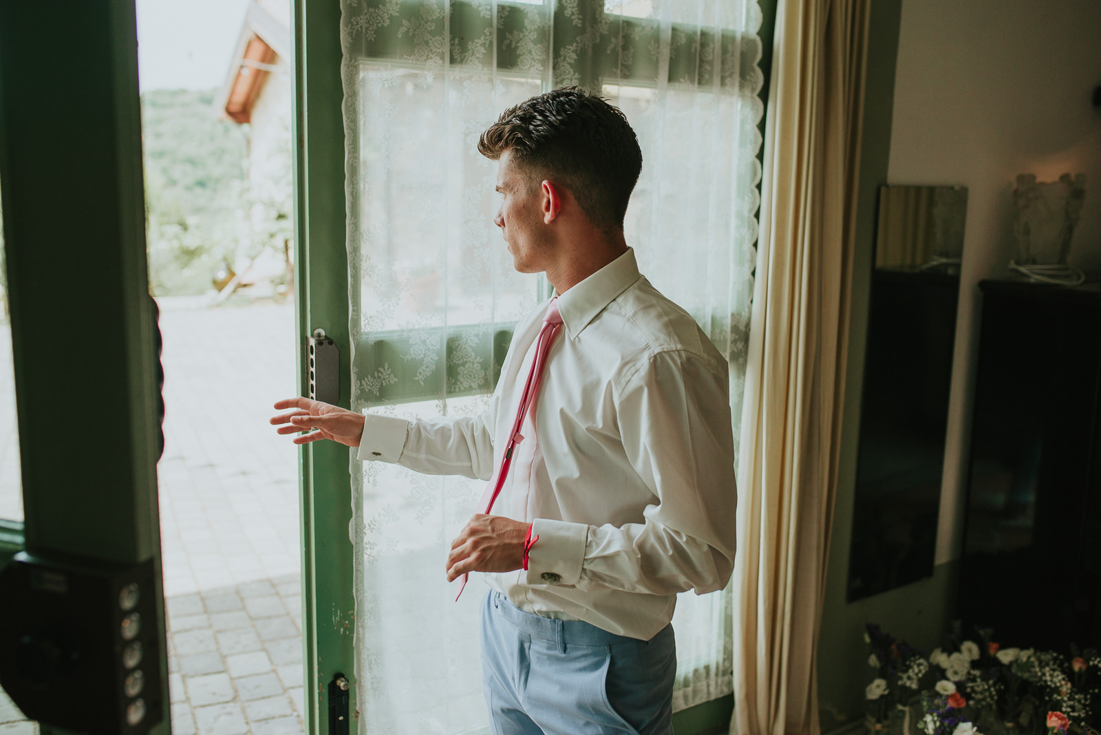 bride's son looking out of the window waiting for wedding