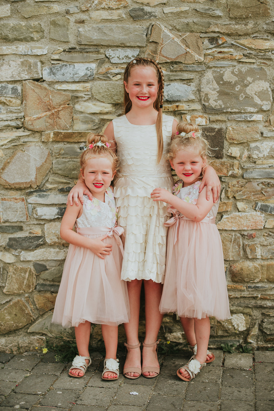 group picture of flower girl before wedding wearing pink pastel dresses