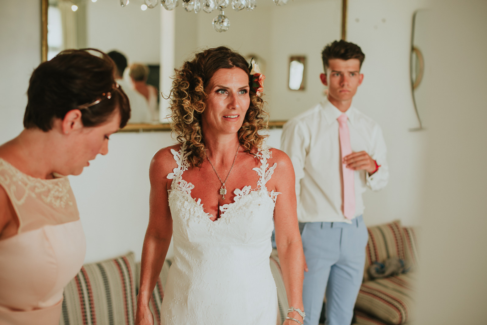 bride getting ready with her son and bridesmaid