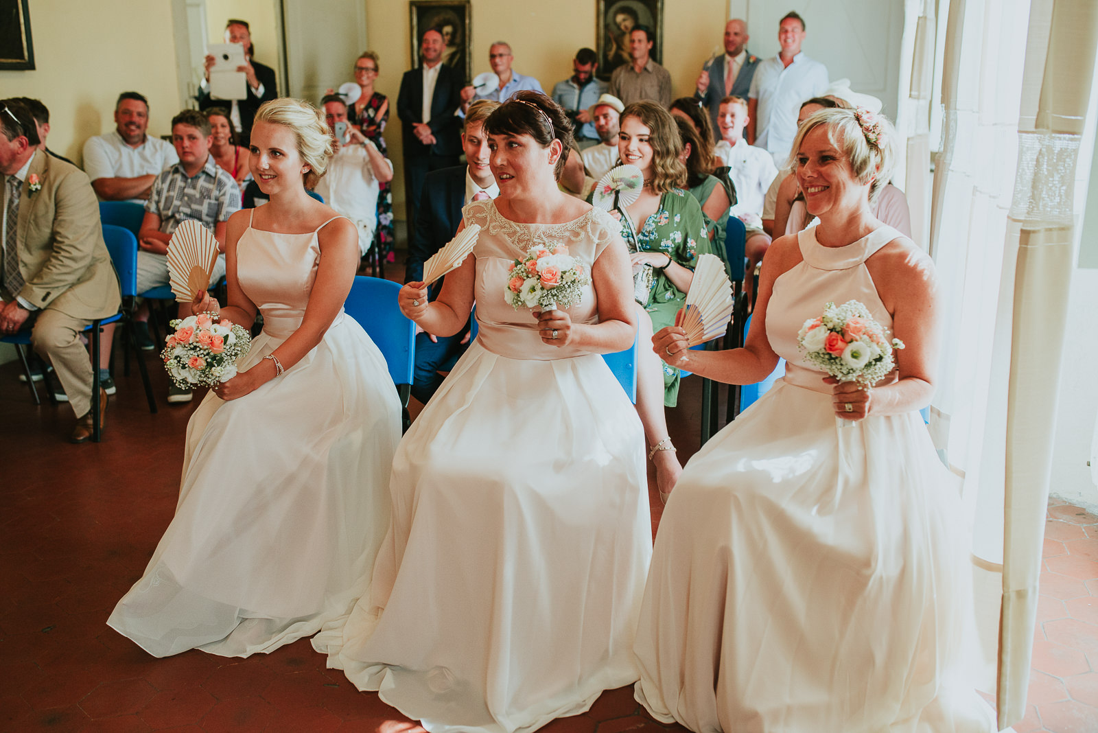 smiling bridesmaids wearing a light pink pastel dress
