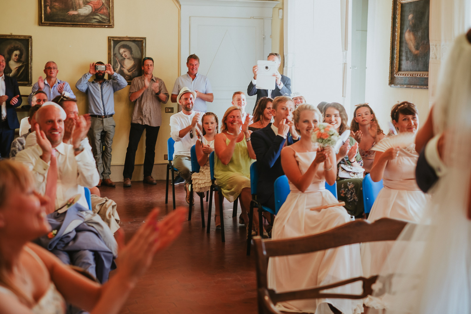 wedding guests cheering at bride and groom