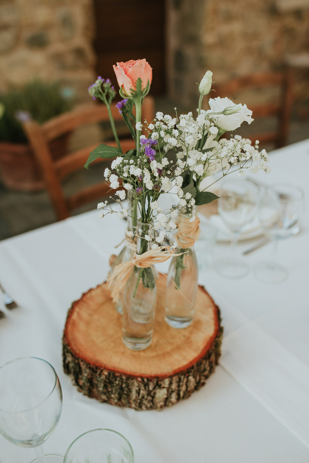 wooden centerpiece idea for wedding with white pink and lilac flower decoration