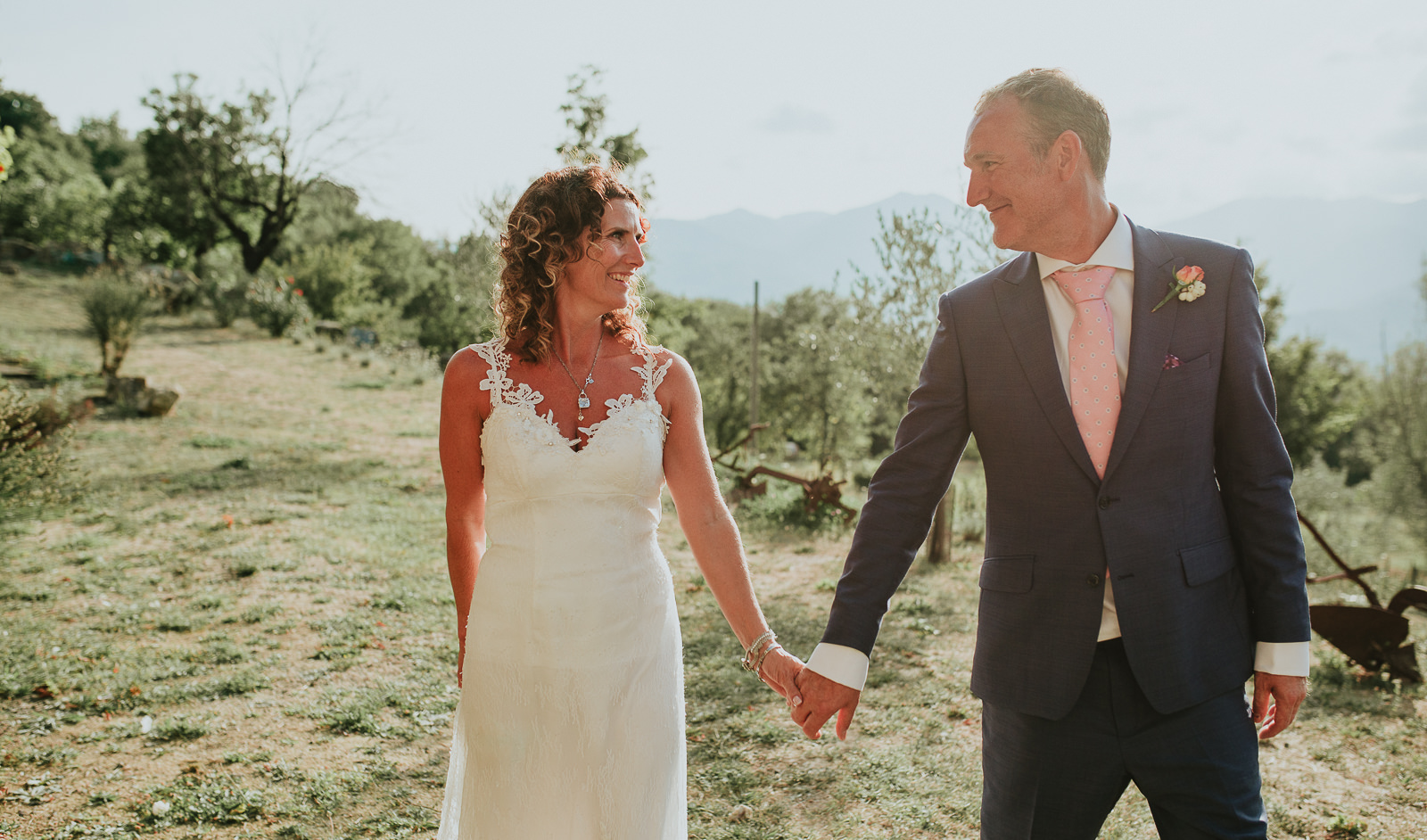 bride and groom walking during golden hour in Podere Conti Tuscany