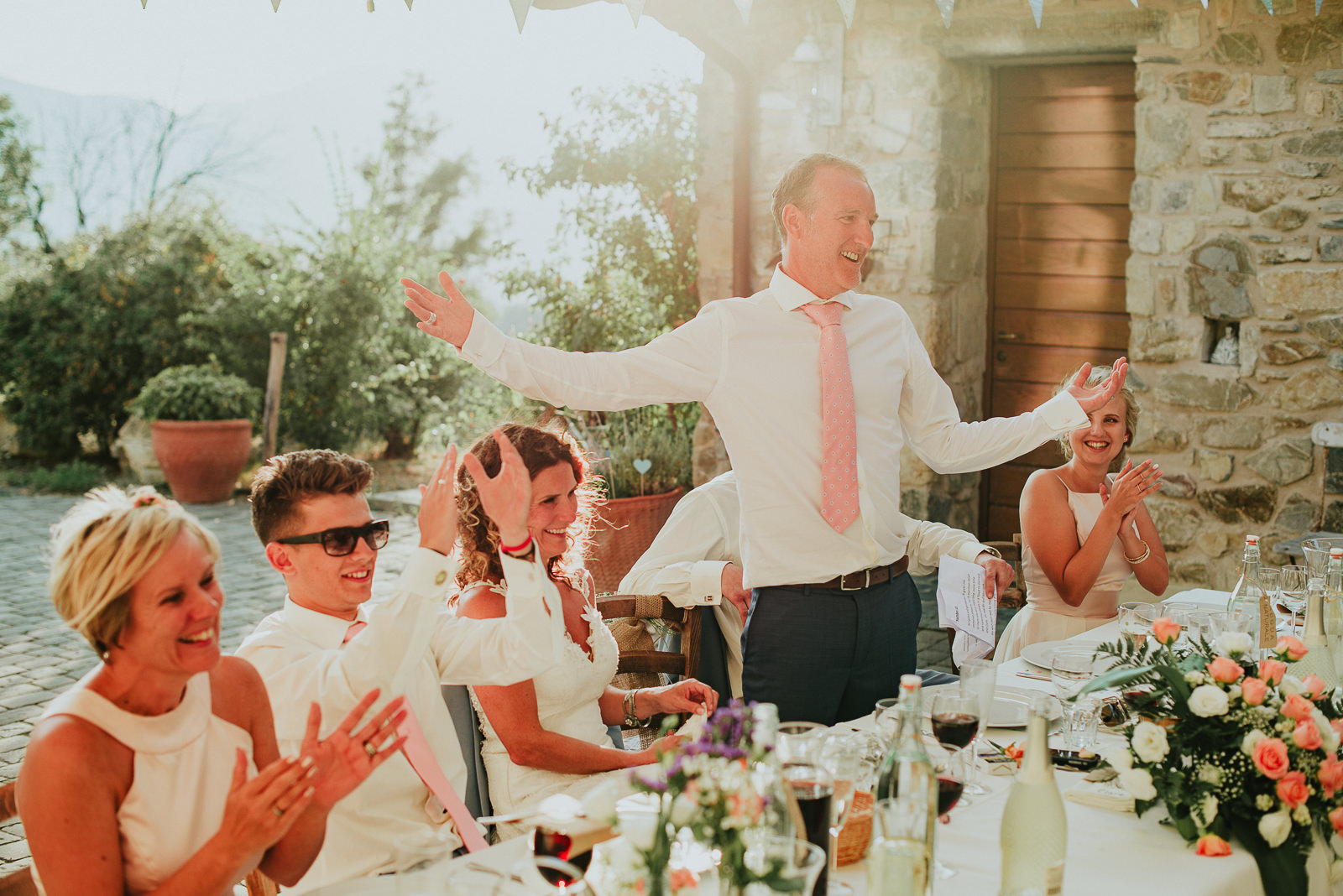 groom smiling while having a speech during a destination wedding in Tuscany Podere Conti