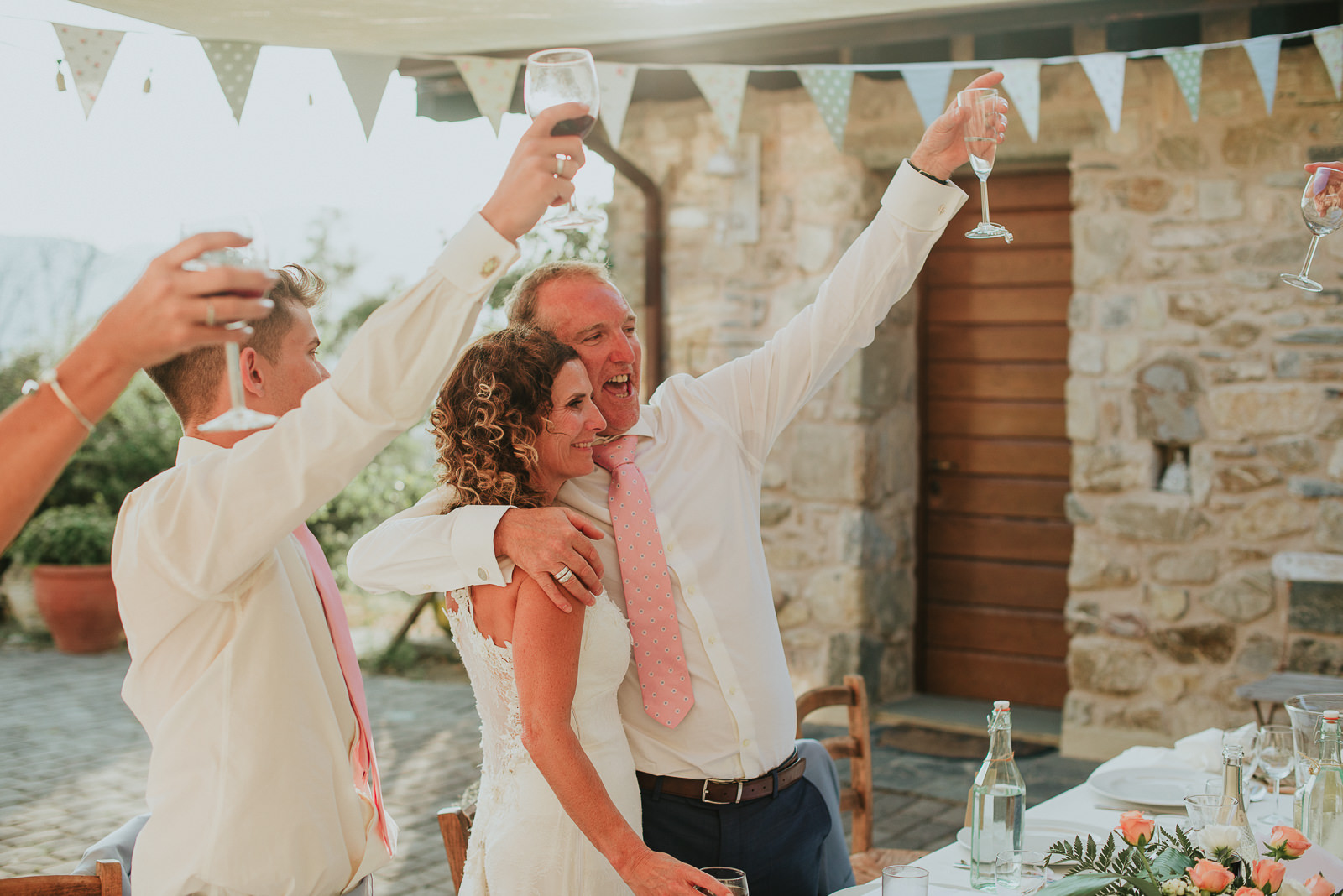 bride and groom toast during their destination wedding in Tuscany Podere Conti