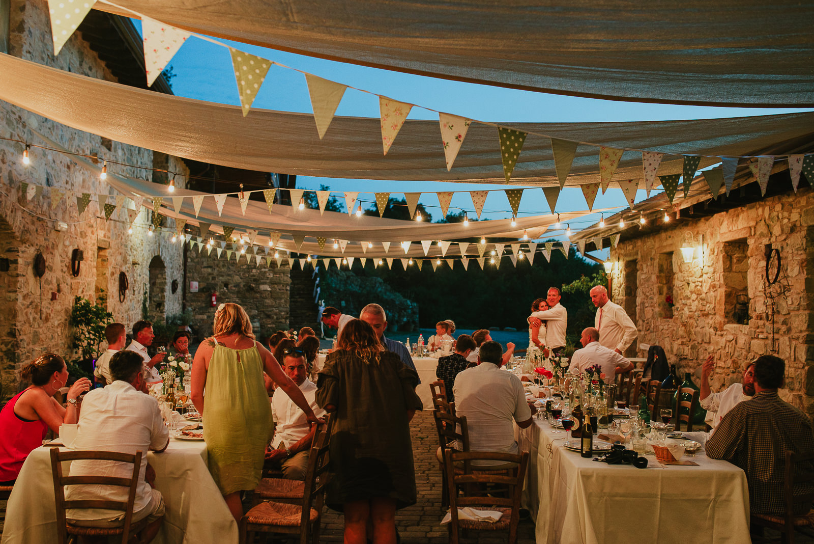Outdoor destination wedding setup by night in Podere Conti Tuscany