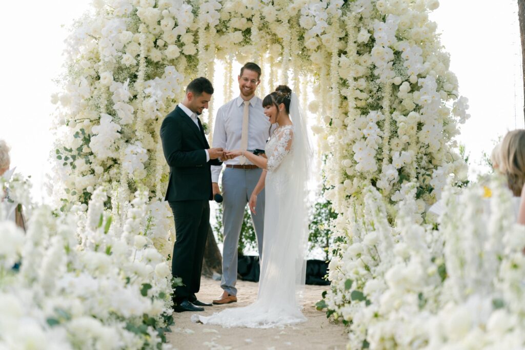 couple getting married putting the ring on bride finger